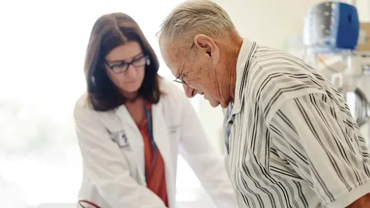 Doctor helping patient