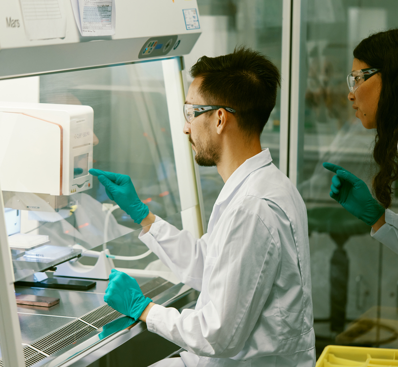 Scientists working in a laboratory with protective gear