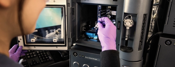 Scientist preparing sample in laboratory microcopy Workspace