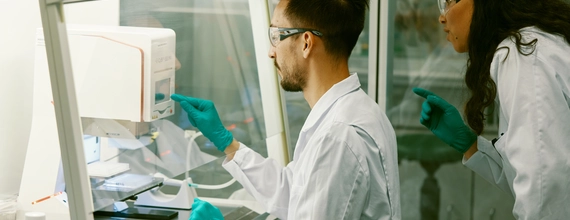 Scientists working in a laboratory with protective gear