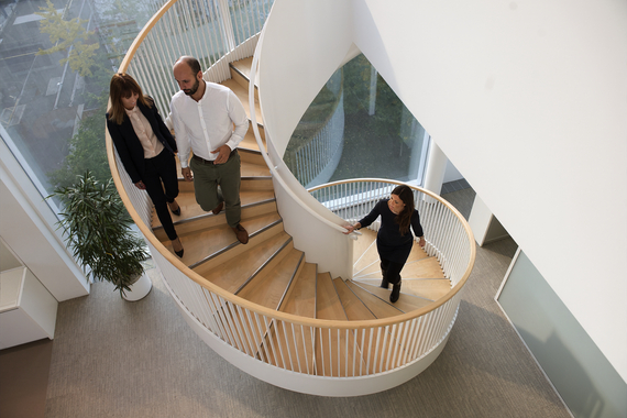 People on spiral staircase in modern office building