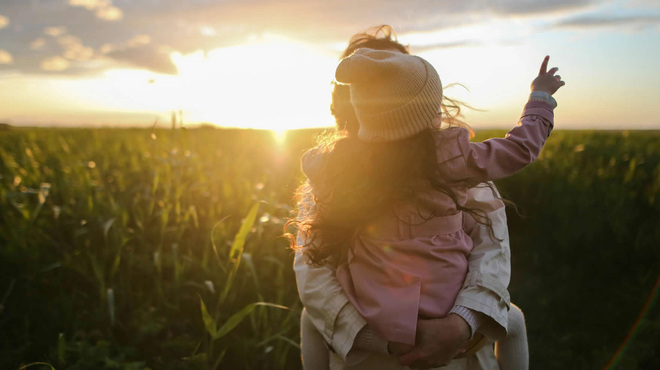 Woman with child outdoors in open field