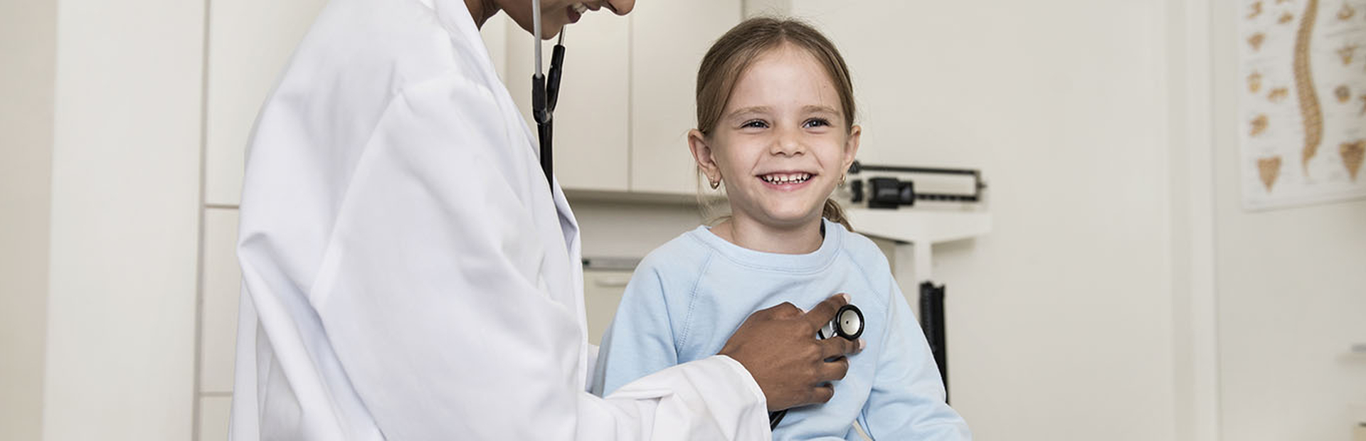 Girl getting a check by a doctor