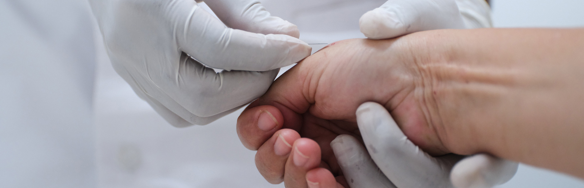 Doctor takes blood sample from a patient