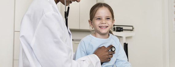 Girl getting a check by a doctor
