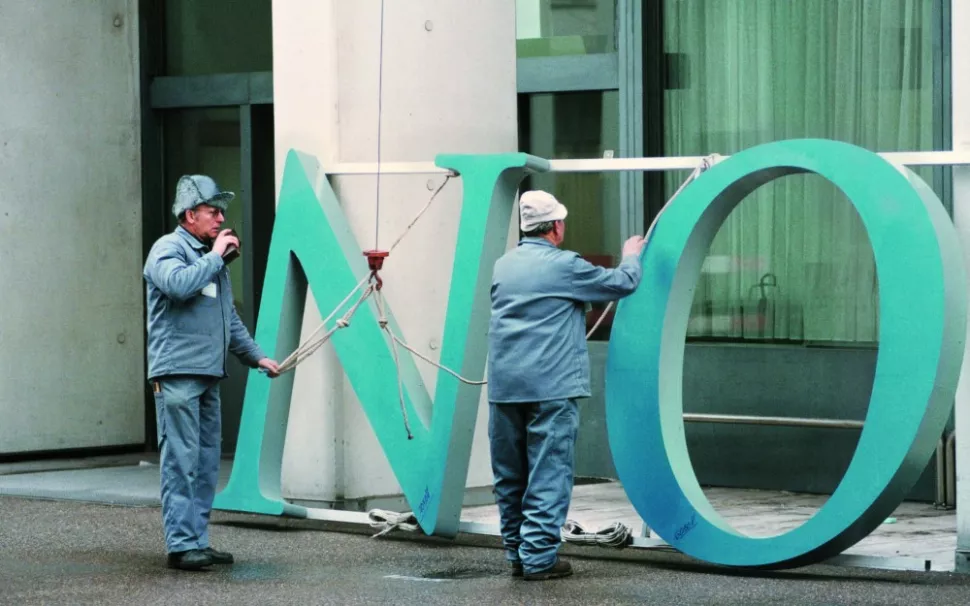 Photograph of the old Novartis logo being changed out at the Novartis St. Johann site in Basel