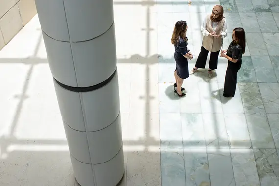 Three women of different nationalities are discussing