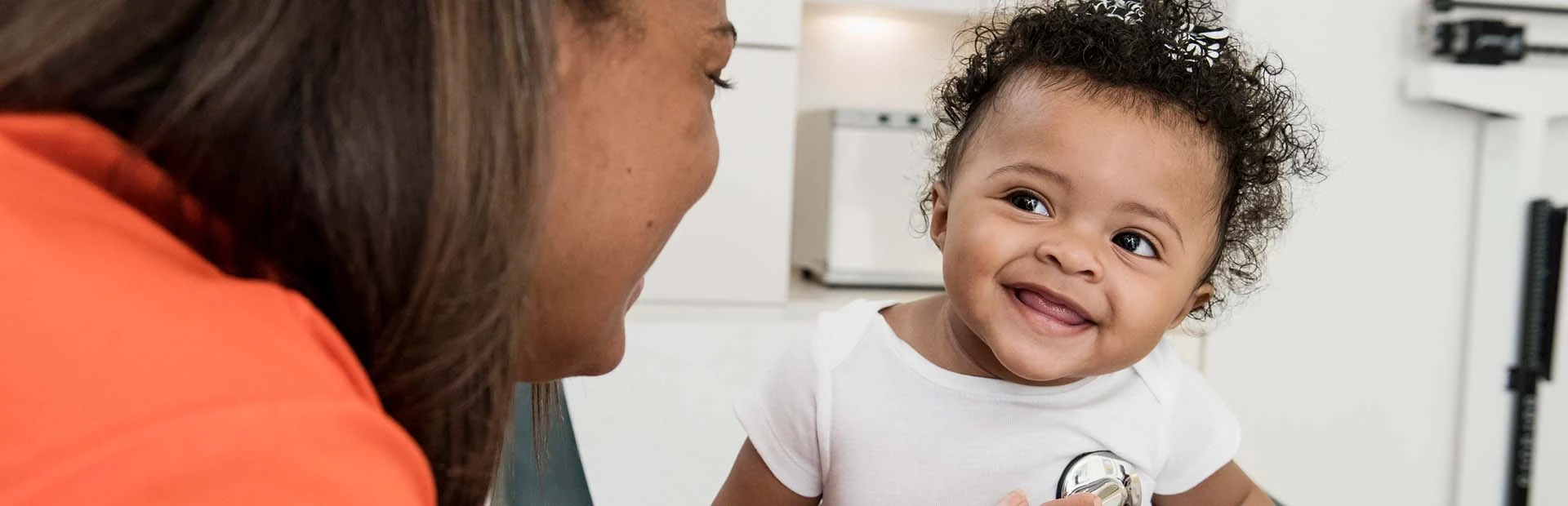 Ärztin hört den Herzschlag eines Babys ab