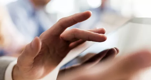 Hände halten ein digitales Tablet