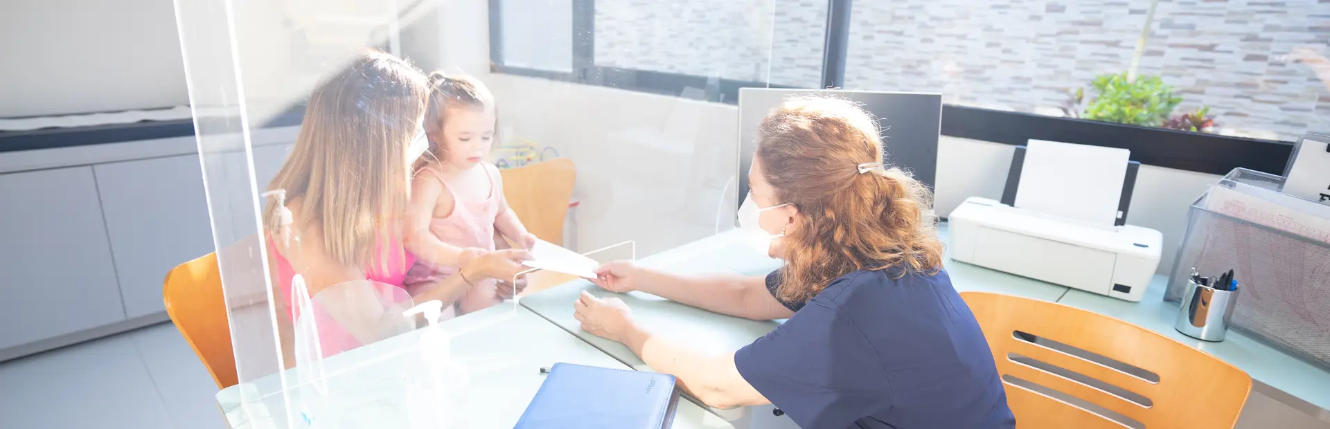 Doctora entregándole un diagóstico médico a la madre de un bebé en constula