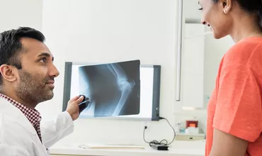 Doctor checking patient x-ray