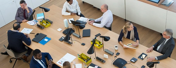 A photo of people in a meeting hall