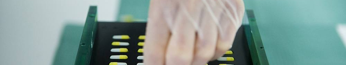 A hand with a pill tray