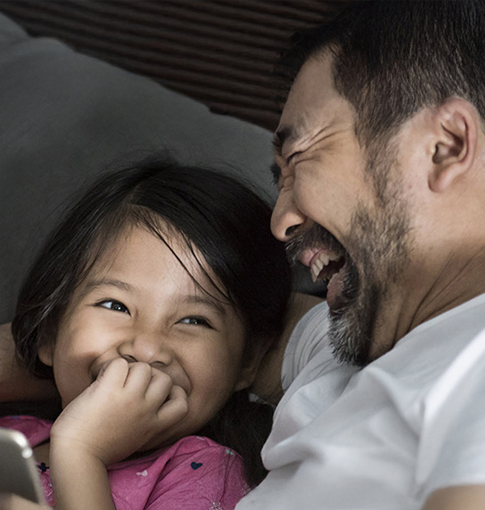 A father and daughter laughing