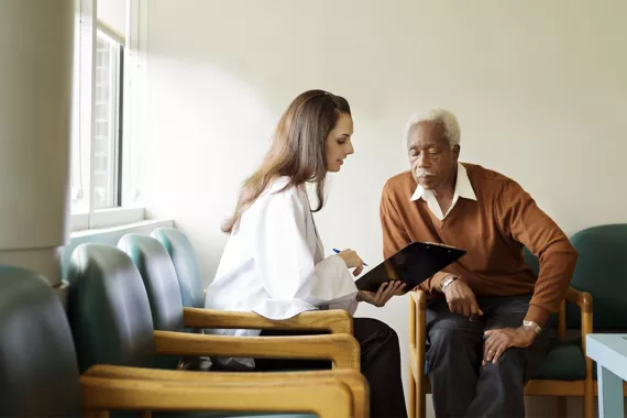 Doctor talking with a patient in a room