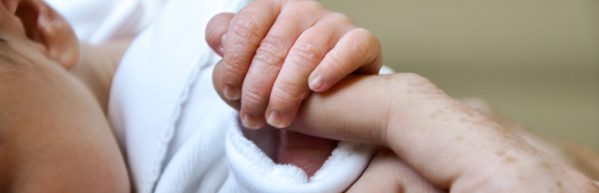 Newborn grasping finger image