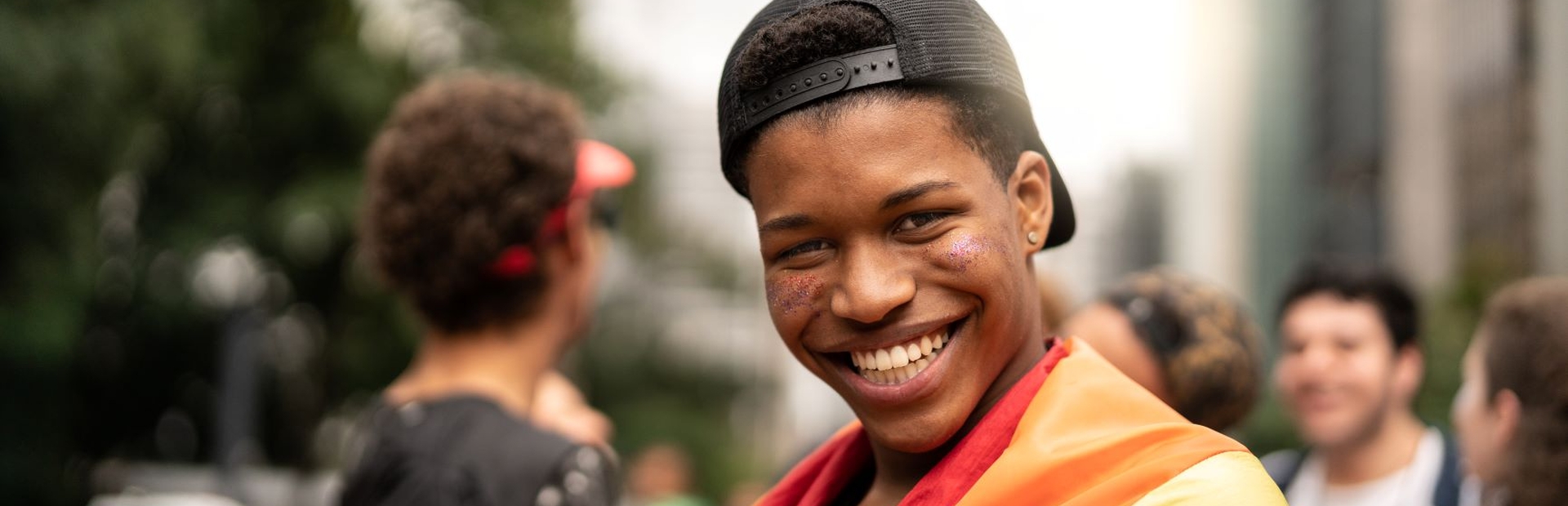 Photo of man wearing pride flag