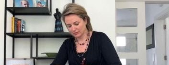 Image of Ciara O'Connell signing the Diversity Charter Ireland