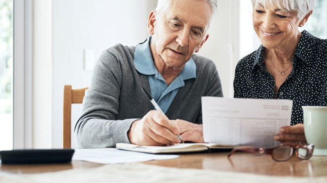 Elderly couple looking at papers