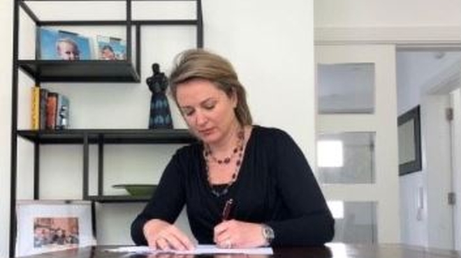 Image of Ciara O'Connell signing the Diversity Charter Ireland