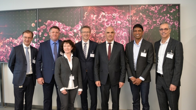 Group photo of Novartis Executives together with Federal Councillor Alain Berset in front of the Wall of Hope.