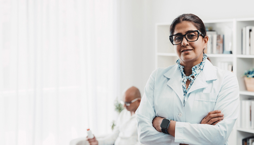Doctor with patient in background
