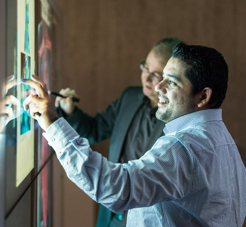 People working on touchscreen