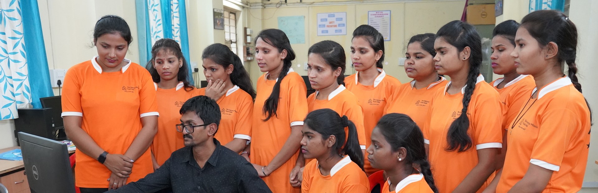 A group of computer students with their instructor