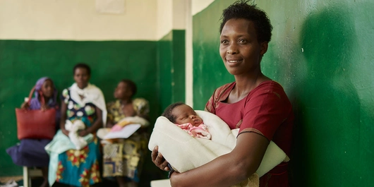 Mother waiting with an infant in a clinic
