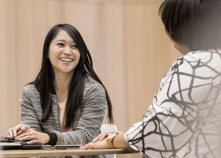 Woman smiling and talking with a colleague