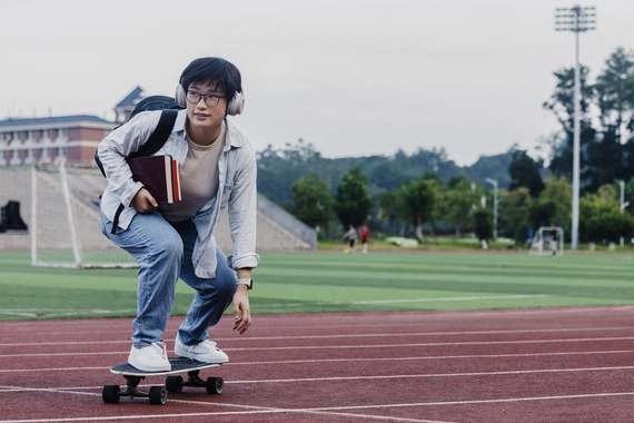 young student skateboarding