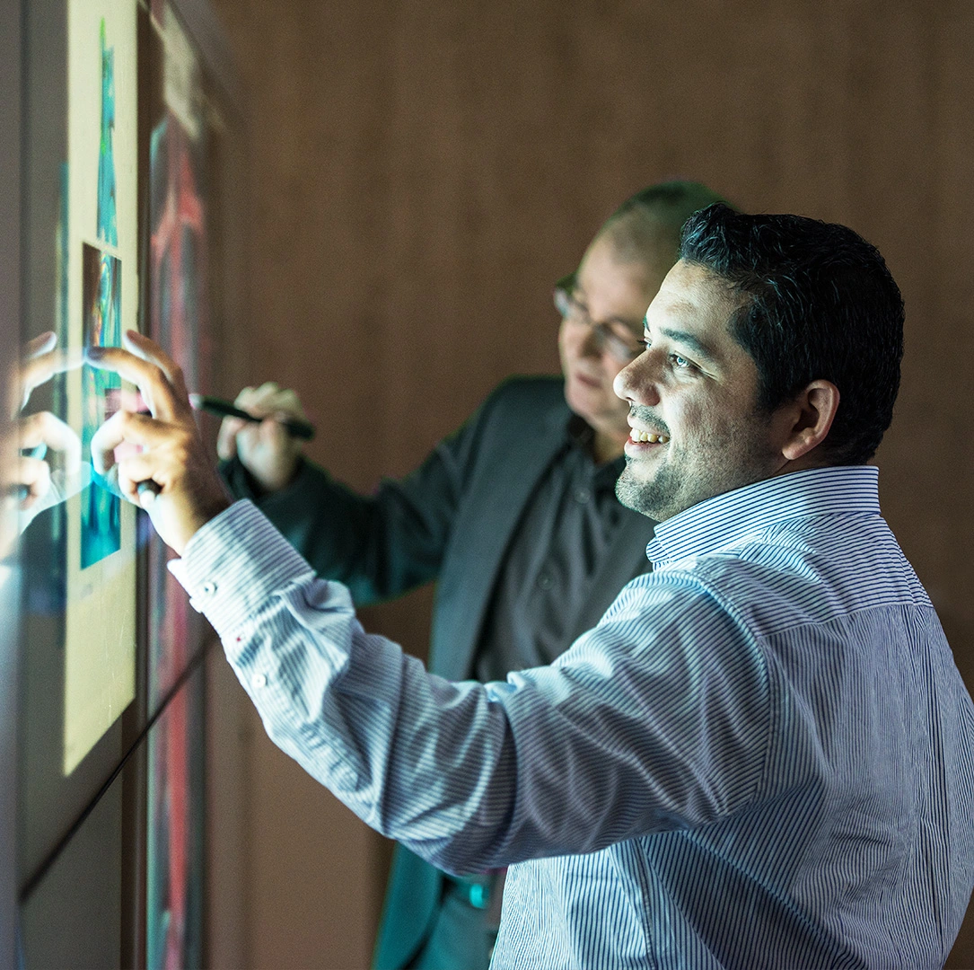 People working on touchscreen