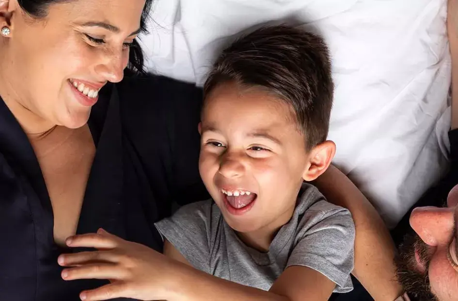 parents-snuggling-with-son-sma