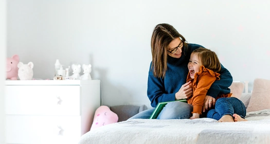 mother-daughter-cuddling-on-a-bed-kid-room-banner-v2