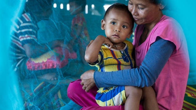 mother child insecticide treated net image
