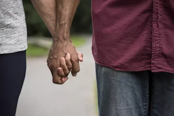 Two people holding hands.