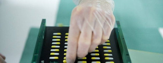 A hand with a pill tray