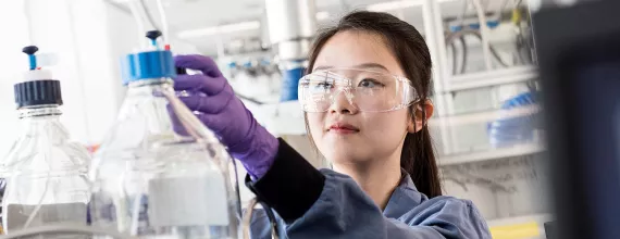 Scientist working in lab with purple gloves