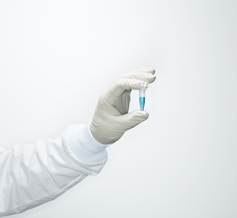 Scientist hand holding a vial