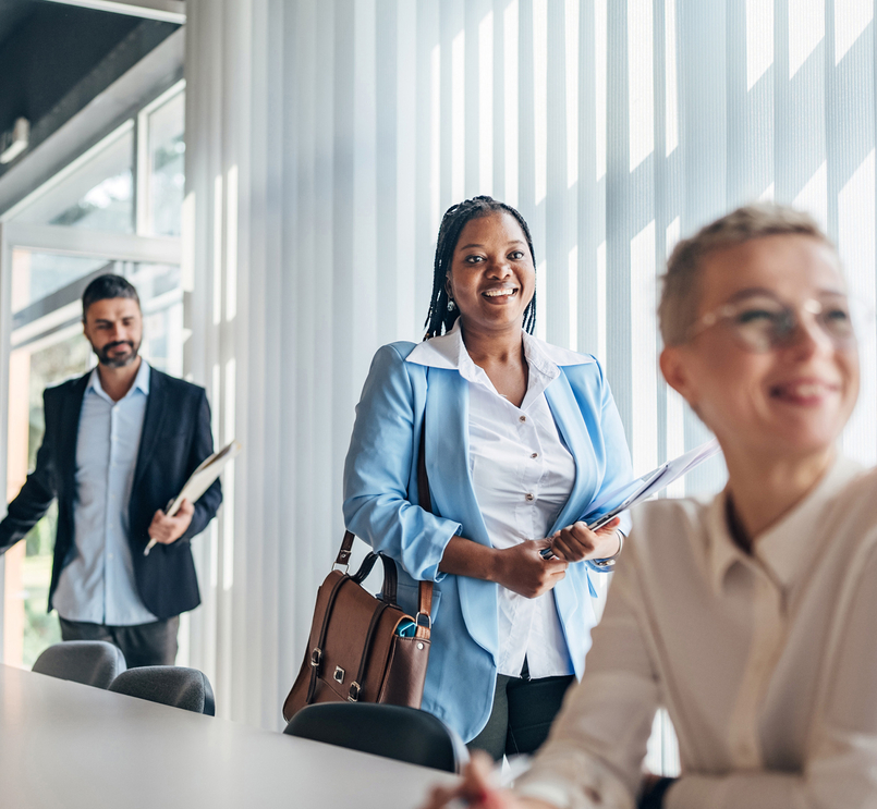 Business persons entering meeting room