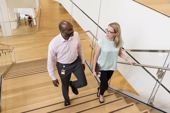 Two Novartis associates walking up a set of stairs