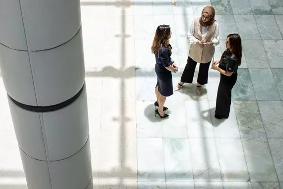 Three business women discussing outside