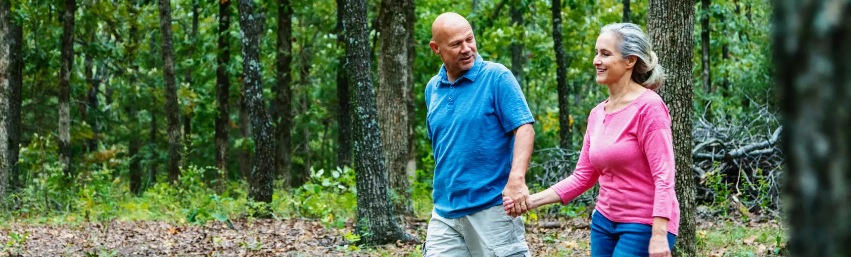Couple walking through forest