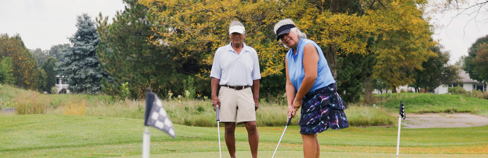 Two elderly playing golf