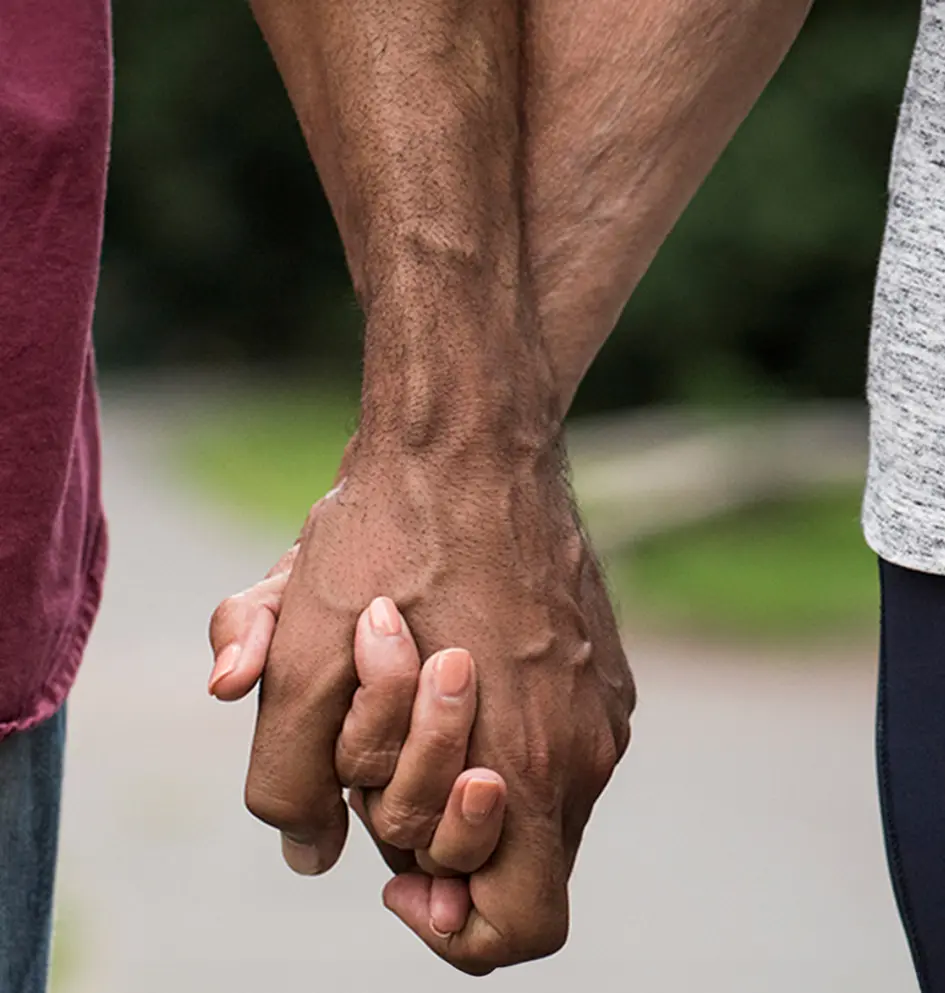 Two people holding hands