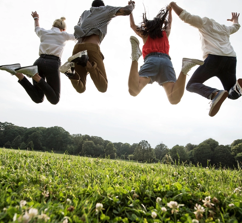 Group of young adults jumping
