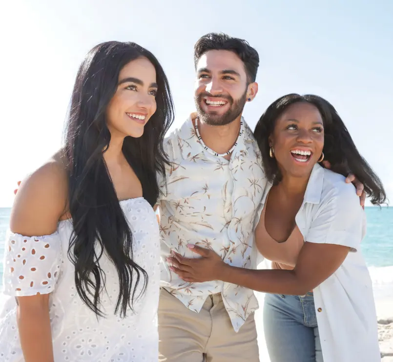A group of friends hanging out on the beach on a sunny day