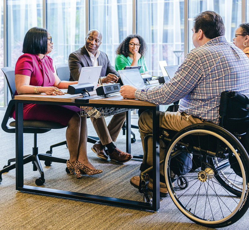 Group of professionals in a meeting at a table in an office