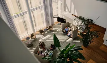 Bright modern lounge with people socializing and relaxing near large windows