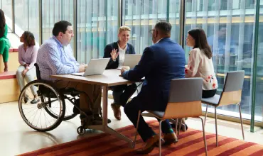 Group of professionals meeting around a table in an office